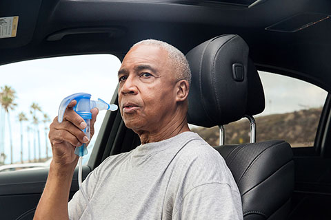 Nebulizer BlackMale SittingInCar PortableNebulizer PariTrekWithBatteryCharger 4745 LCS